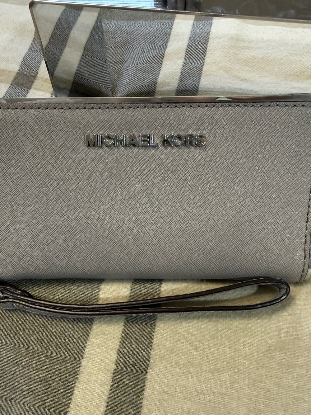 Michael Kors wristlet wallet in a pale gray great for travel.